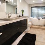 bathroom remodel with black contemporary vanity and quartz vanity countertops