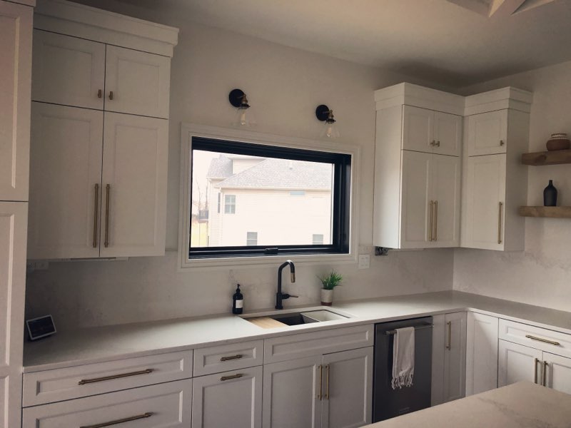 kitchen design with white quartz countertops and white painted cabinetry