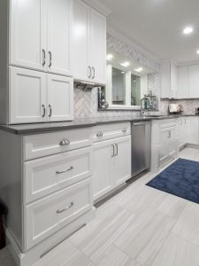 Kitchen remodel white painted cabinetry, grey vinyl flooring and grey quartz countertops