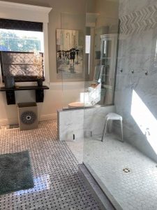 basketweave floor tile and glass walk-in shower