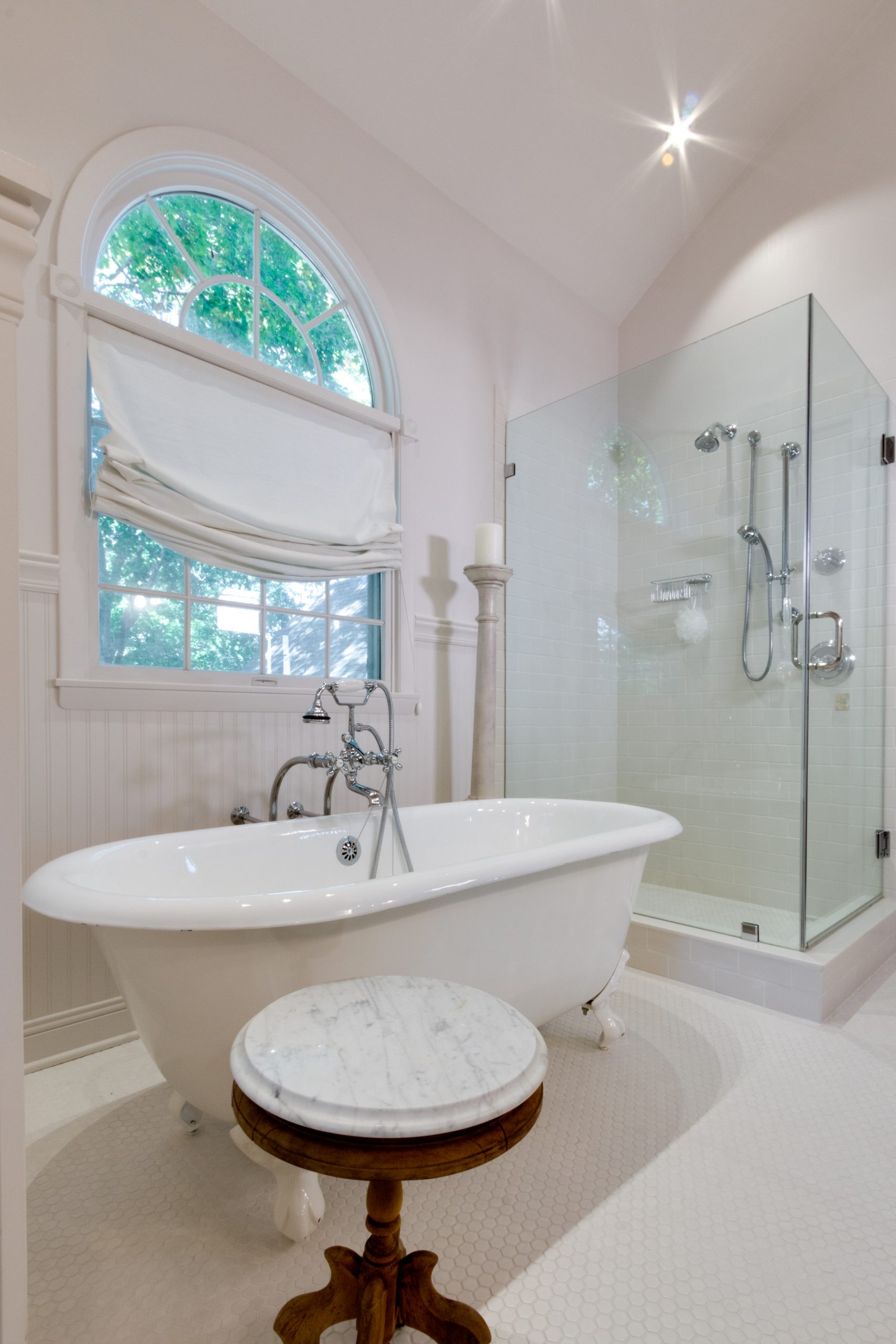 bathroom remodel with white tile, clawfoot tub and glass walk-in shower