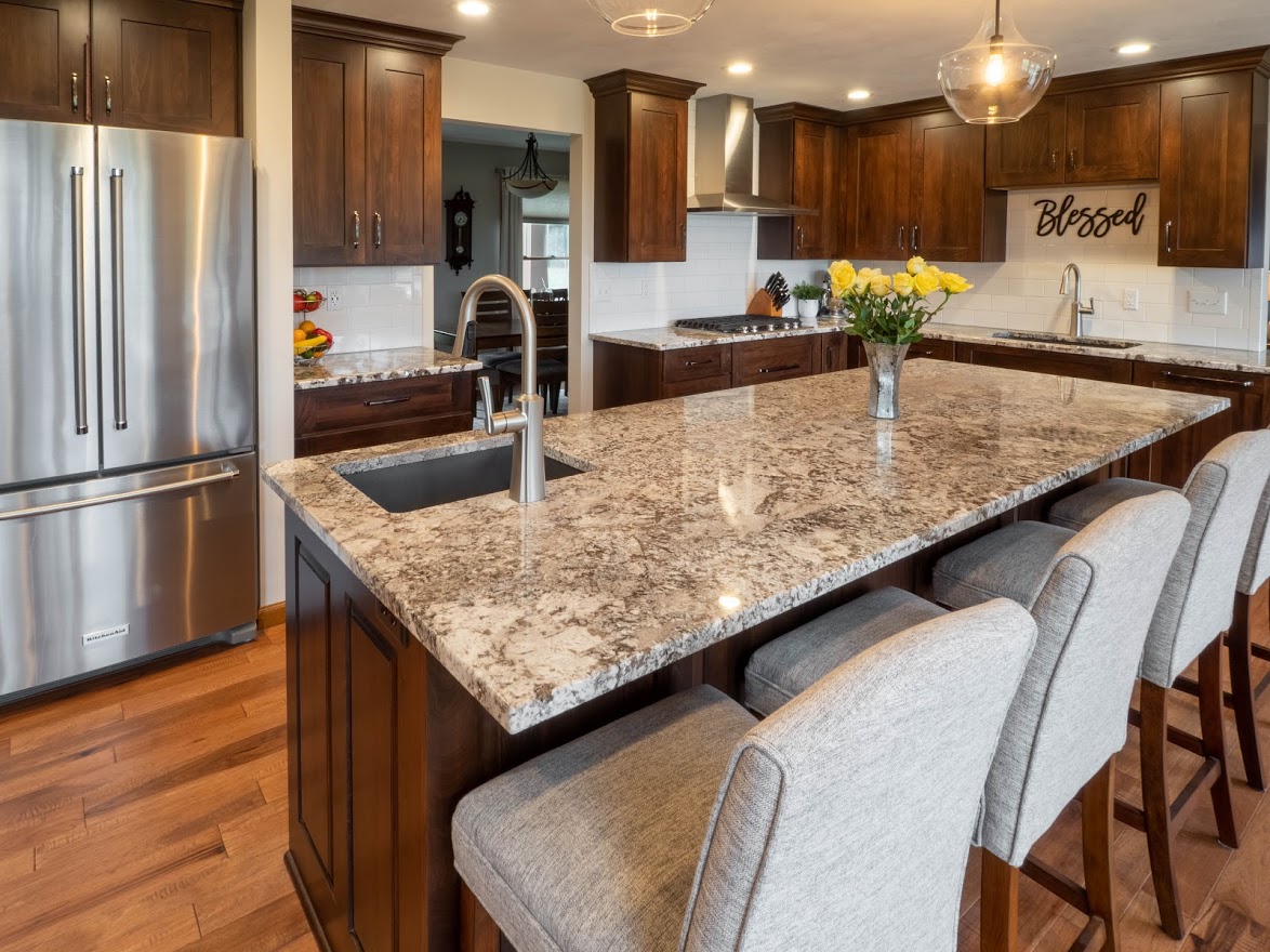 Kitchen remodel with a stained wood island, granite countertops and stainless steel appliances