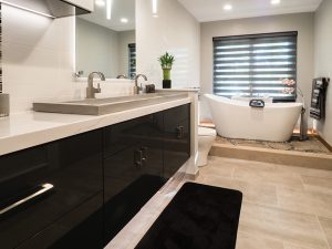 modern bathroom remodel with waterfall vanity tops and sleek black vanity cabinets