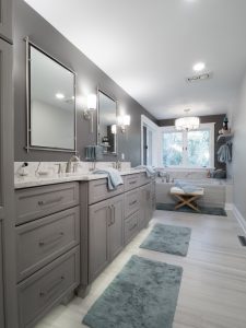 bathroom remodel with grey painted cabinetry and vinyl flooring