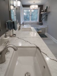 bathroom remodel with white veined granite vanity countertop