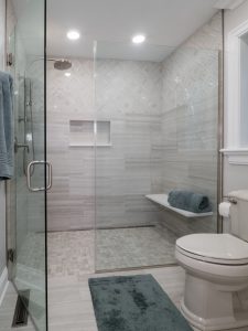 bathroom remodel with large glass walk-in shower with wall tile and floor tile