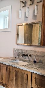 bathroom remodel with wooden vanity and granite vanity top