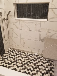shower remodel with hexagon floor tile in the shower and marble wall tile