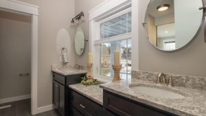 double vanity with granite countertops and dark painted cabinets