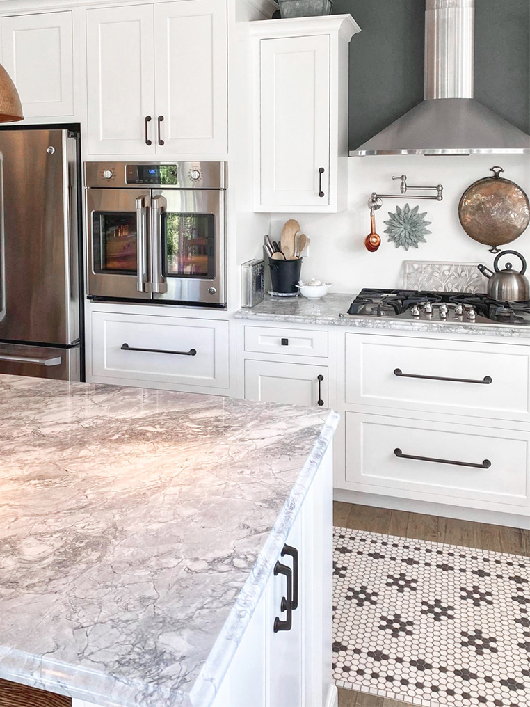 Modern farmhouse kitchen design with marbled quartz countertops
