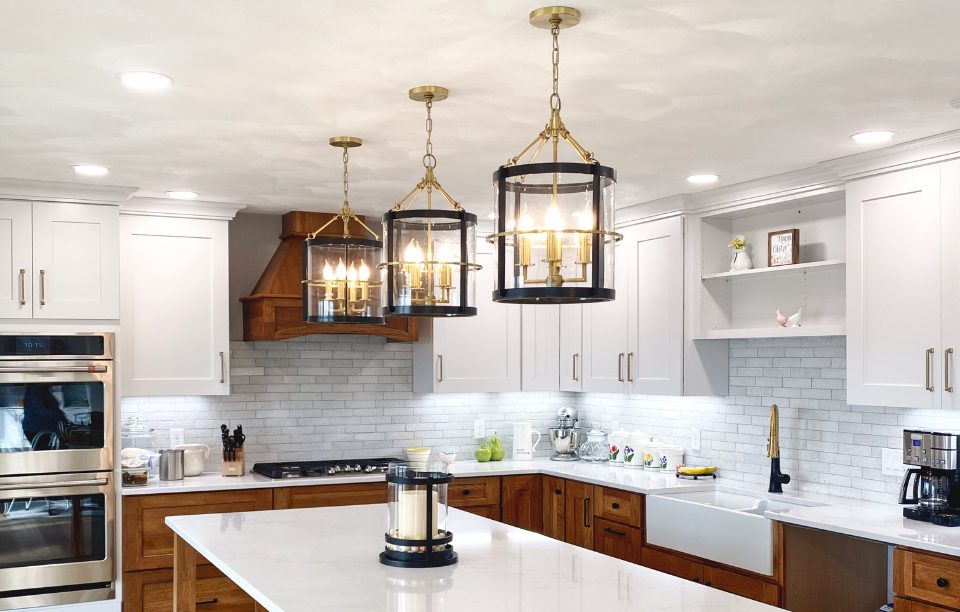 gold and black pendant lighting over kitchen island