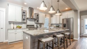 Neutral transitional midwest modern farmhouse kitchen design with granite island and grey cabinets