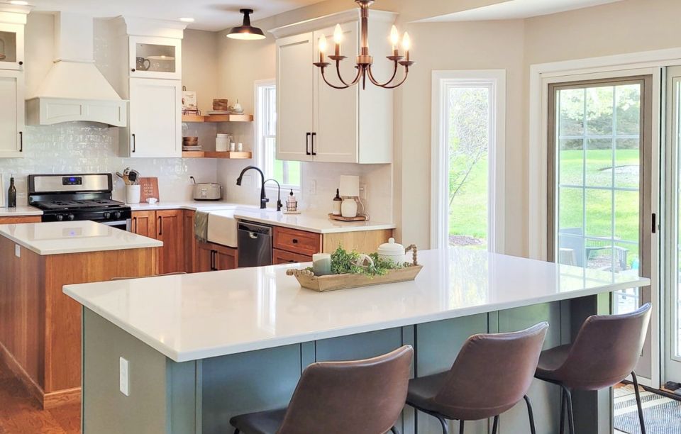kitchen design with white quartz countertops, sage green island, and hardwood floors