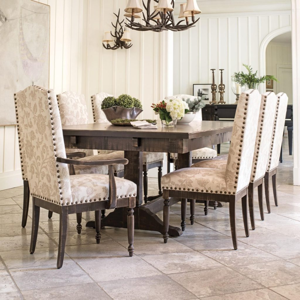 Dining room furniture set with farmhouse table, ivory upholstered chairs, and fall antler decor 