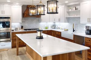 kitchen remodel with white countertops, white cabinets, and a stained wood kitchen island