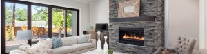 licing room with white furniture and grey natural stone fireplace