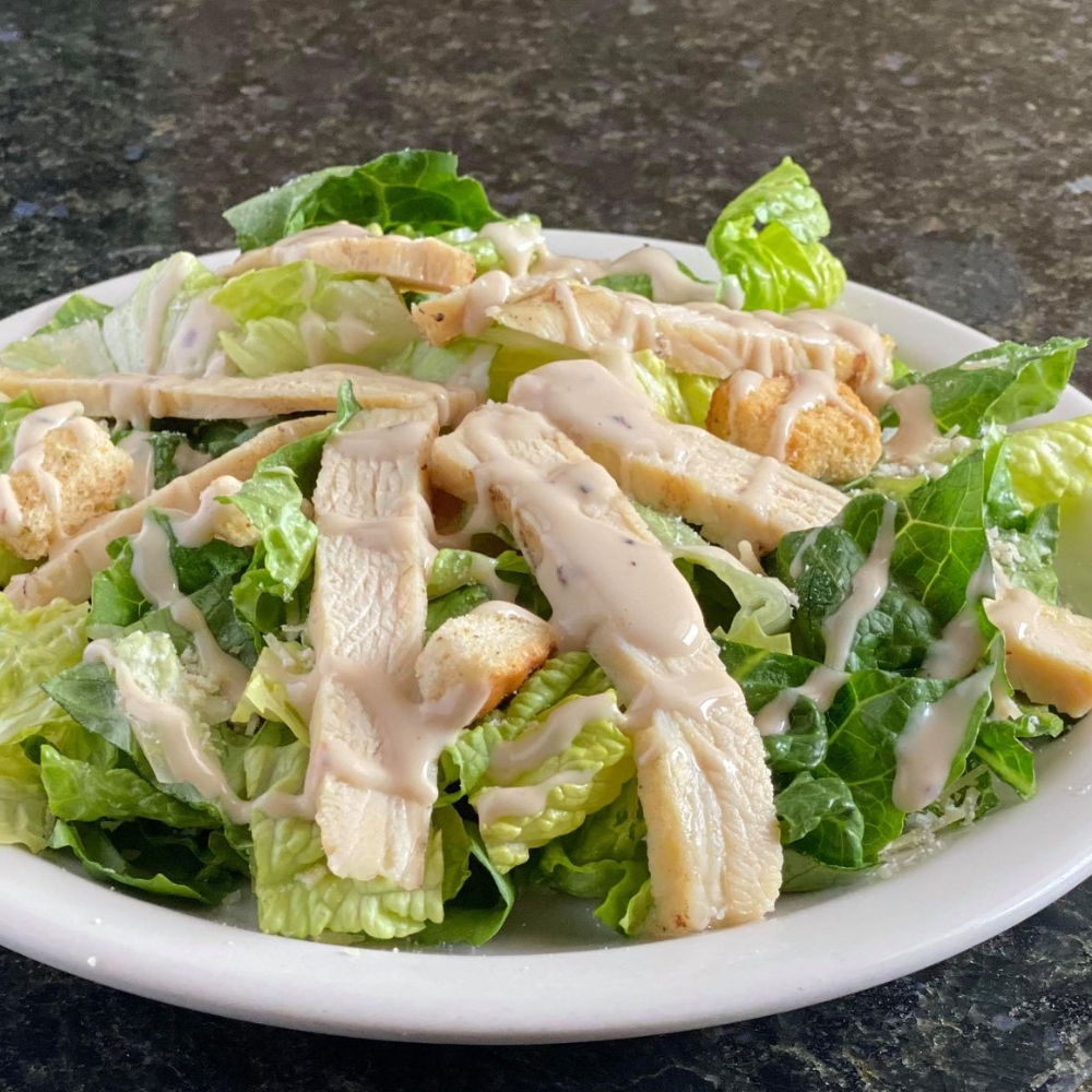 chicken cesar salad on a granite table at hearthrock cafe in rockford, il