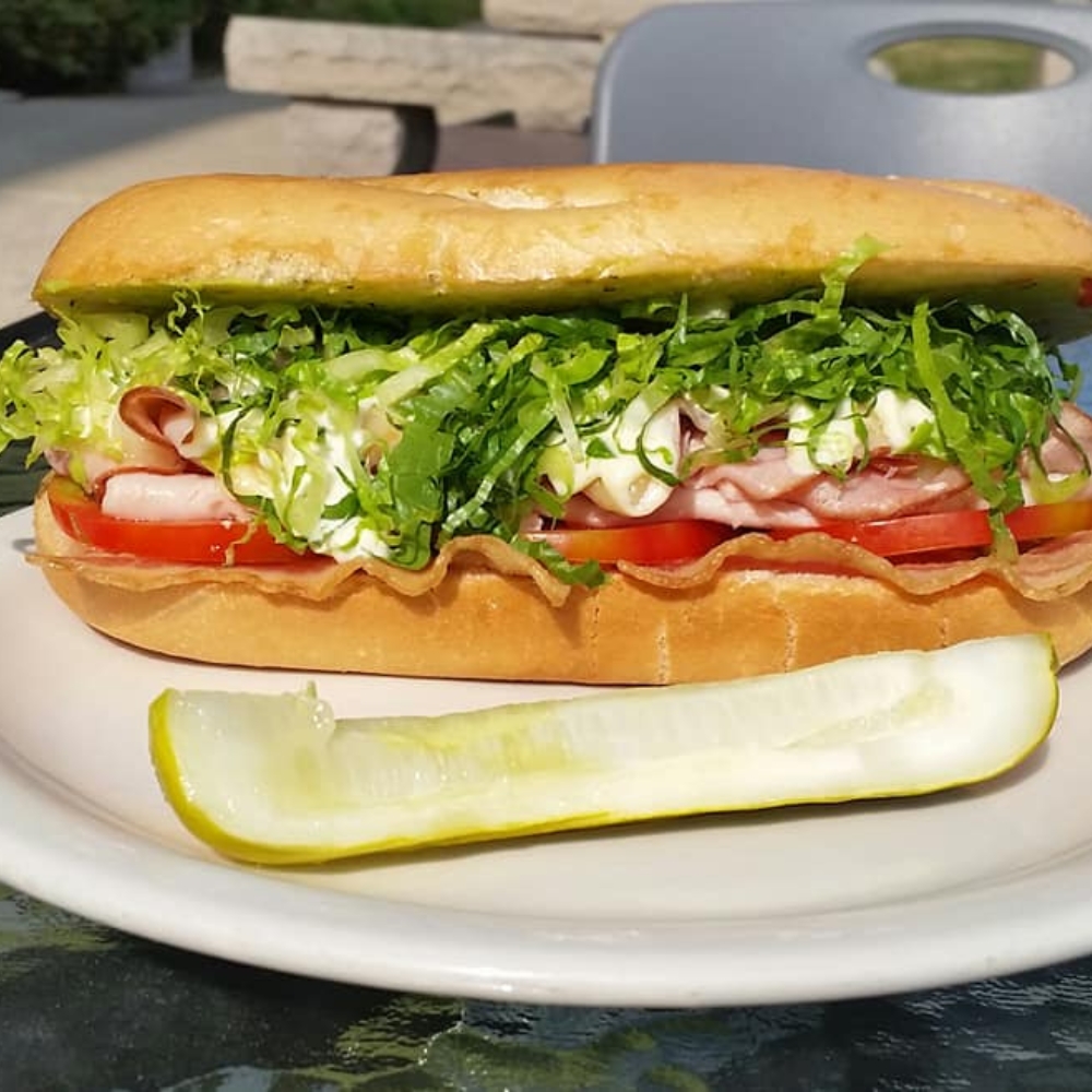 classic sub sandwich with a pickle on a table at hearthrock cafe