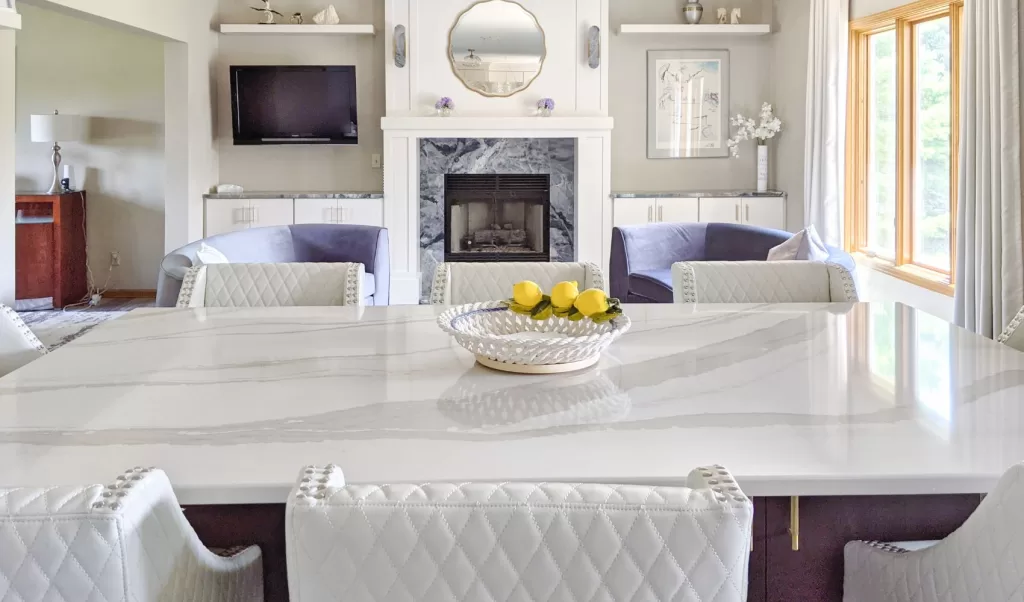 white marbled quartz countertop on an island with a gas fireplace