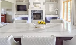 white marbled quartz countertop on an island with a gas fireplace