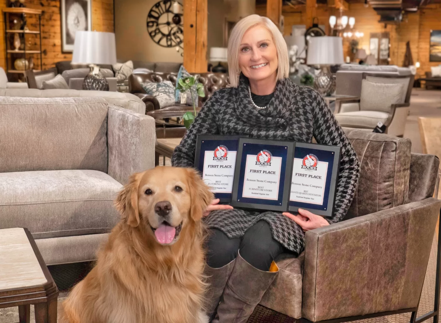 kim benson holding plaques to show Benson Stone Co is voted the best furniture store in rockford, il three years in a row!