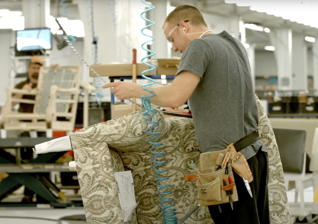 Furniture craftsman upholstering an American-made chair